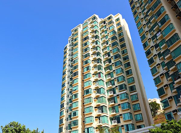 A tall building with many windows and balconies.