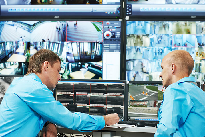 Two men in front of a computer screen.