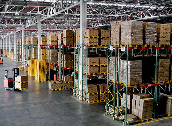 A warehouse filled with lots of boxes and racks.