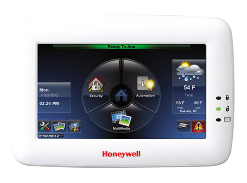 A white honeywell home control panel with buttons and icons.